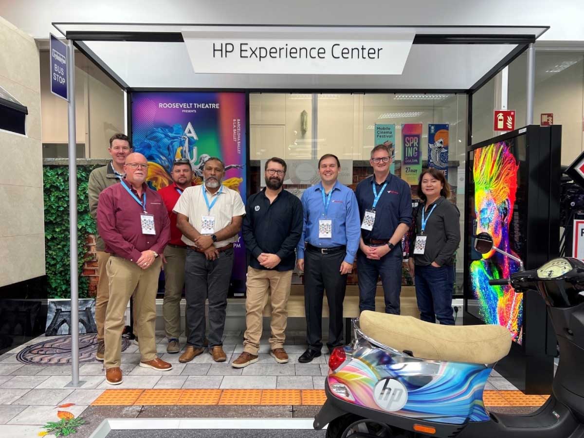 Delegates touring printed display and vehicle wrap applications at the HP Experience Center